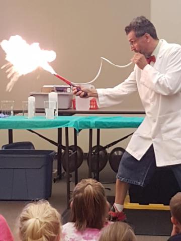 photo of experiment. scientist shooting flames out of tube