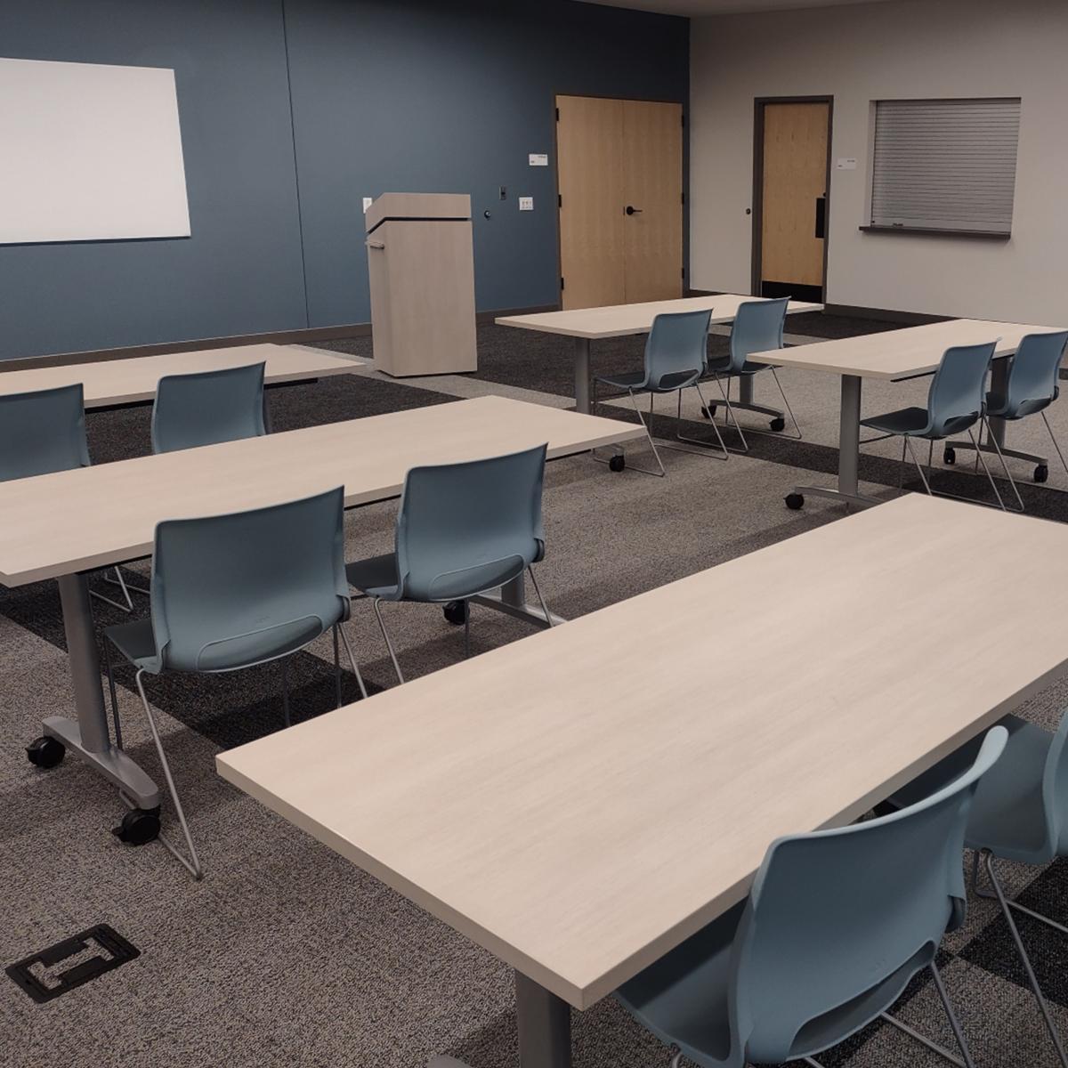 Community room set up with 6 tables and 12 chairs