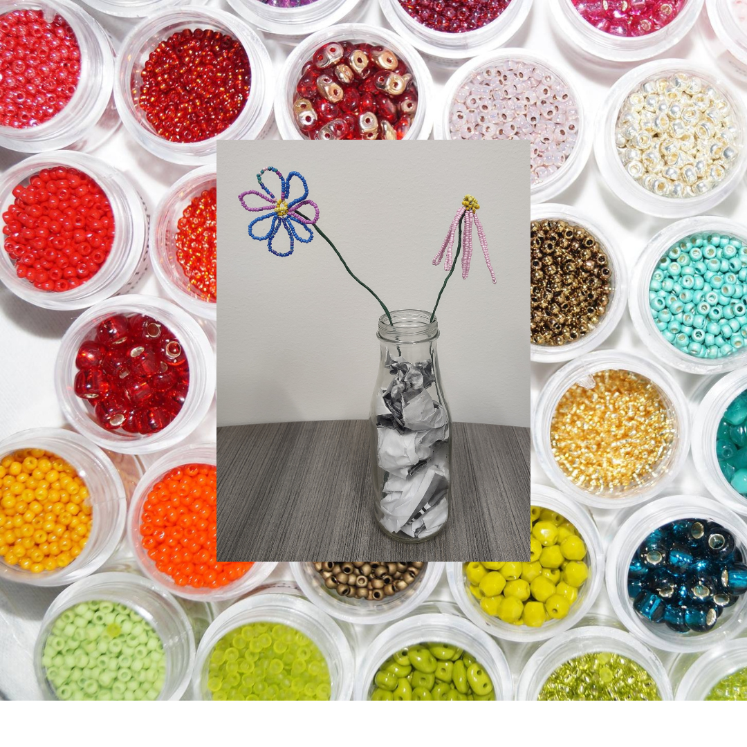 Beaded flowers on a backdrop of rainbow seed beads in organizing containers