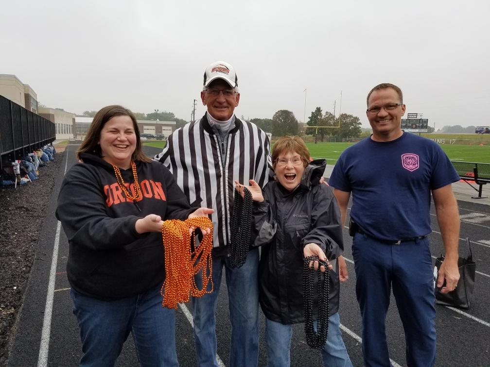 attendees handing out orange beads